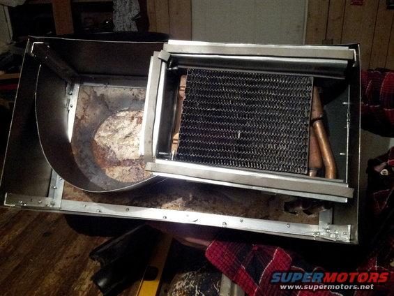 Car heater core assembly with copper tubes and fins inside a metal housing