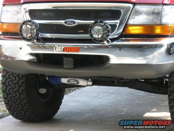 Red 1998 Ford Ranger front bumper with KC lights and 'Dirt Sports' sticker