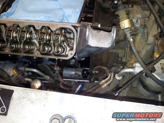 Engine compartment with valve cover removed, showing rocker arms and springs