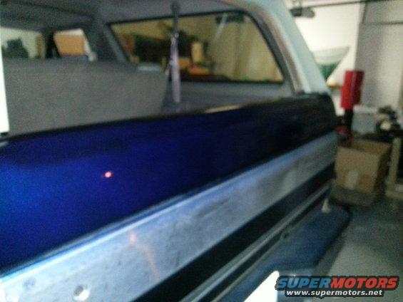 1994 Ford Bronco rear quarter panel with blue paint and silver trim