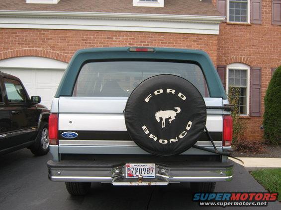 1996 Ford Bronco rear view, silver and teal, with spare tire cover showing 'Ford Bronco' and a horse emblem