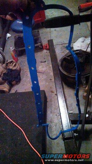 blue gasket hanging on a rack in a garage