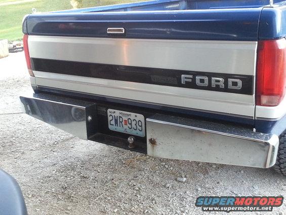 Rear of a blue and silver Ford pickup truck with a chrome bumper and a Missouri license plate