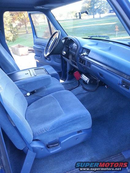 Interior of a 1994 Ford F-250, showing blue seats, dashboard, and steering wheel