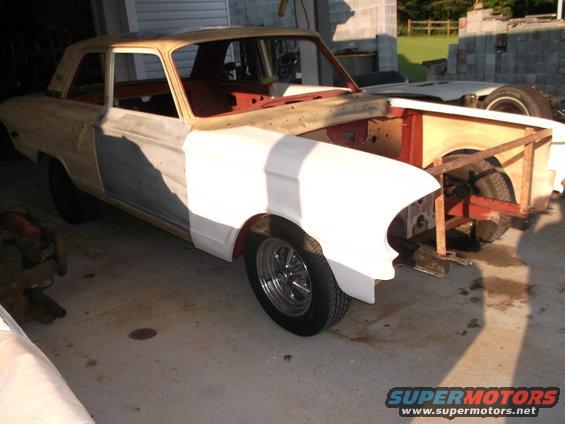 1964 Ford Fairlane body, primer white, undergoing restoration, front end removed, side view