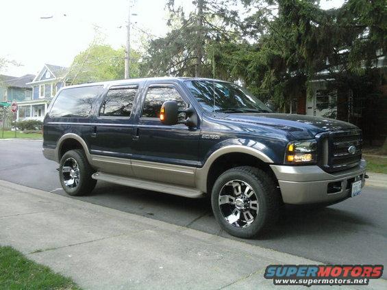 Dark blue and tan 2005 Ford Excursion parked on a residential street
