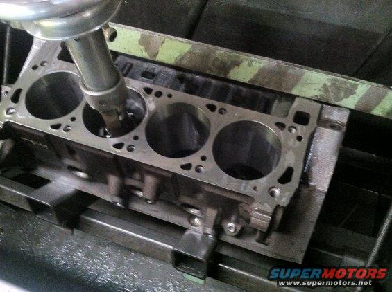 Engine block on a machine with a tool inside a cylinder bore
