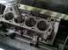 1978 Ford Bronco - A close-up view of an engine cylinder block undergoing machining on a specialized tool.