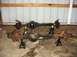 1992 Ford Bronco - Two vehicle axles are displayed on jack stands, one appearing newer and black, the other showing significant rust.