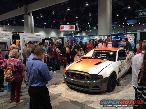 Customized 2013 Ford Mustang GT, orange and white with graphics, 3q-front view