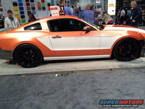 Ford Mustang side profile, custom orange and white paint scheme, black wheels