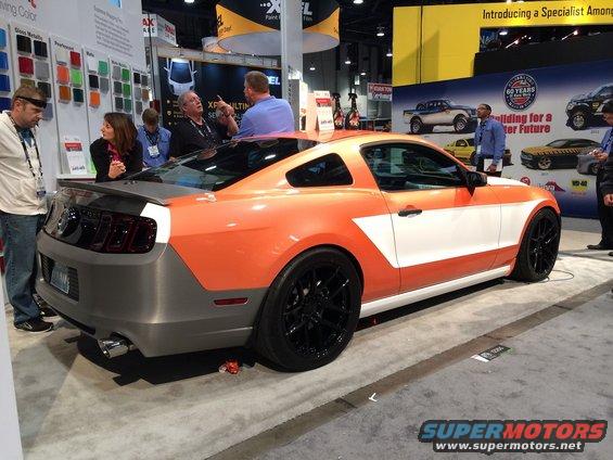 Custom orange and white Ford Mustang on display at a show