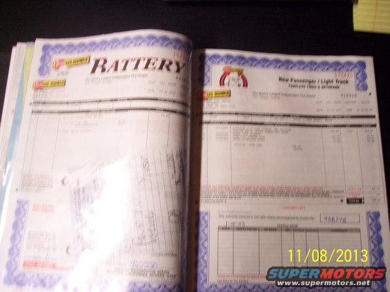 Open album with two pages of vehicle service documents, one labeled BATTERY, the other New Passenger / Light Truck