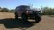 1996 Ford Bronco - This modified Ford Bronco is shown from a three-quarter front angle under a clear blue sky.
