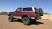 1996 Ford Bronco - This 1996 Ford Bronco features a two-tone paint scheme and off-road tires, with a spare tire mounted on the rear.