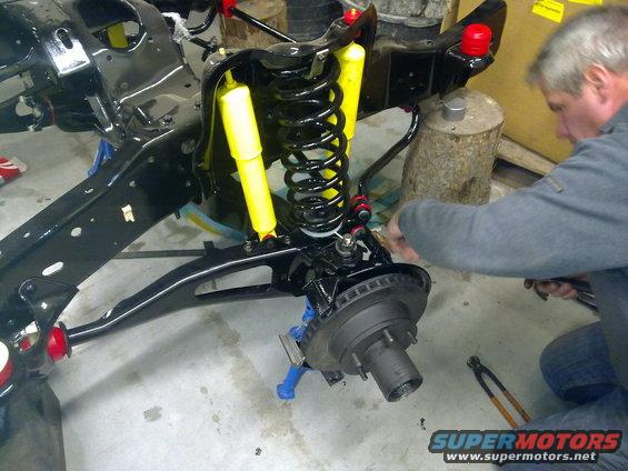 Front suspension assembly with yellow shocks and black springs