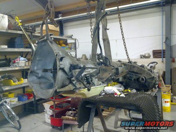Transmission and transfer case assembly hanging from chains