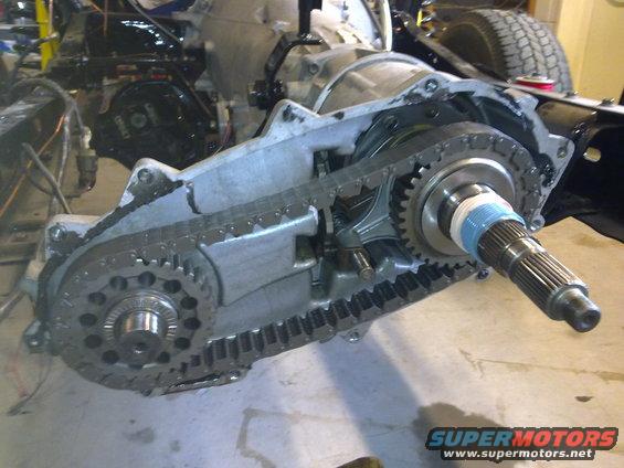 Transfer case assembly showing chain and gears, with output shaft visible