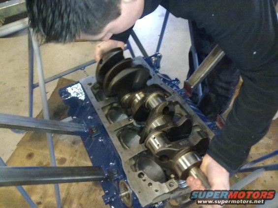 Mechanic installing crankshaft into engine block