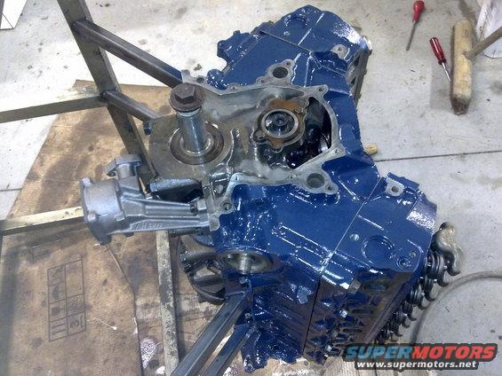 Blue engine block on stand with visible internal components