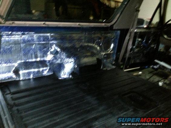 Back of SUV with sound deadening material on the side panels and a black ribbed floor