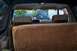 1986 Ford Bronco - Rear interior of a 1986 Ford Bronco, showing seats and dashboard area.
