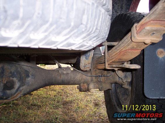 1991 Toyota Pickup/SR5 rear axle, leaf springs, and tire. The vehicle appears to be in used condition
