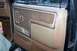 1986 Ford Bronco - Interior door panel details of a vehicle, a fabric insert and storage pockets.