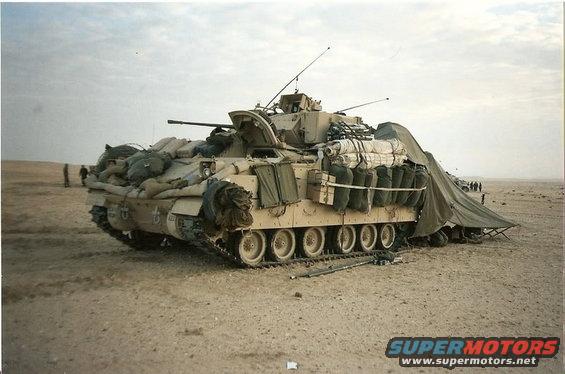 armored personnel carrier loaded with gear in a desert landscape