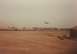 1982 Ford Bronco - Military vehicles and aircraft are visible in a desert environment with a train in the background.