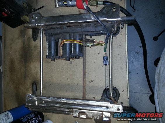 Power seat base mechanism with motors and wiring harness
