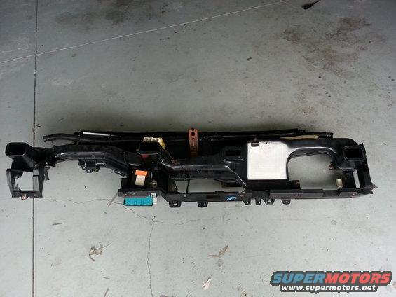 Black plastic dashboard frame with air vents and electrical connectors