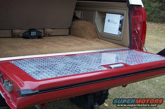 1990 Ford Bronco interior cargo area with diamond plate flooring and amplifier