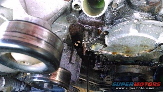 Engine part with pulleys and coolant leak
