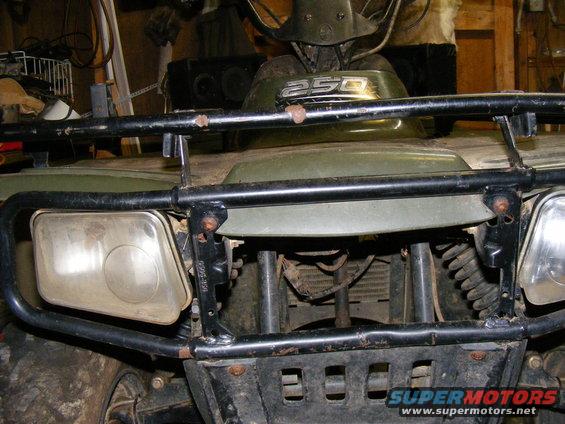 Green ATV with a black roll cage and headlights. The number 250 is visible on the front
