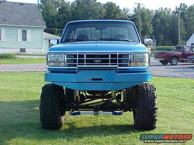 Blue 1992 Ford F-150 front view with lifted suspension and large tires