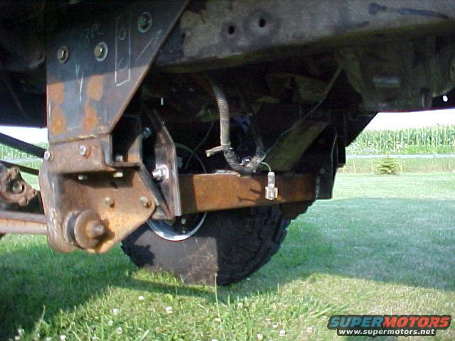 Close-up of truck undercarriage with visible rust and wiring
