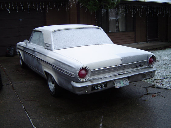 1963 Ford Galaxie 500 parked outside in the snow, rear view
