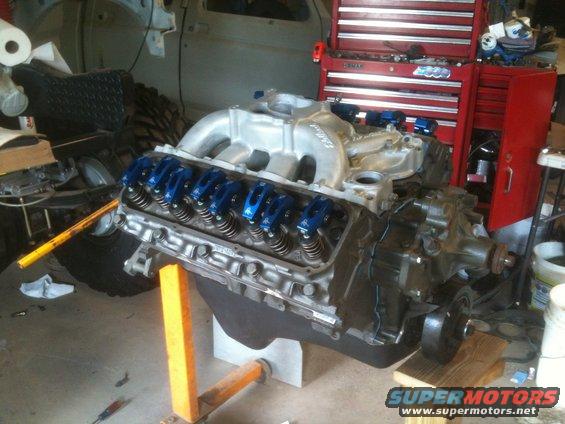 Here she is assembled and basically ready for install (the blocks are there mainly for a little security as in this state it is VERY heavy and was making me a little uneasy on that cheap engine stand. 
You can see my RPM Air Gap intake that I bead blasted and clear coated. 