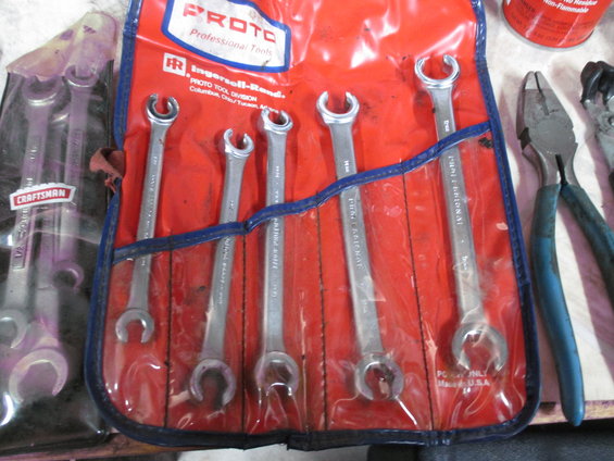 Proto Professional Tools wrench set in red pouch, with Craftsman wrenches visible to the left and pliers to the right