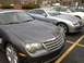 2004 Chrysler Crossfire - Two Chrysler Crossfires are parked in a lot, one in dark gray and the other in silver.