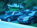 2004 Chrysler Crossfire - Two cars, a 2004 Chrysler Crossfire and a Subaru Outback, are parked in a driveway.