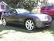 2004 Chrysler Crossfire - A gray Chrysler Crossfire is parked on a grassy lawn with a red SUV in the background.