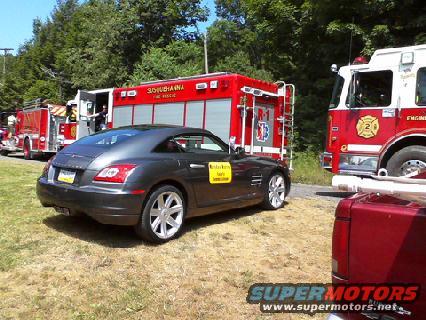 2004 Chrysler Crossfire parked on grass near two fire trucks