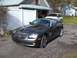 2004 Chrysler Crossfire - A dark gray 2004 Chrysler Crossfire is parked in front of a garage, with a white SUV behind it.