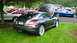 2004 Chrysler Crossfire - A dark gray Chrysler Crossfire is parked on a grassy area with its hood open, alongside other vehicles.