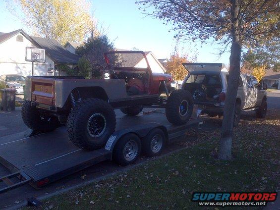 1985 Jeep CJ7 pickup conversion on a trailer, being towed by a pickup truck
