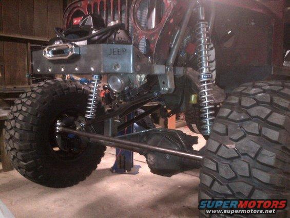 Jeep front end with large tires, winch, and custom bumper with 'JEEP' stamped on it