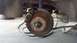 1996 Ford Taurus - The photo shows a close-up view of a vehicle's rear brake rotor and caliper, with visible rust on the components.