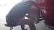 1996 Ford Taurus - Mechanic working on the brake rotor of a red vehicle.